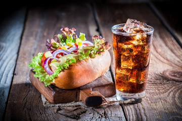 Tasty hot dog with vegetables and sausage