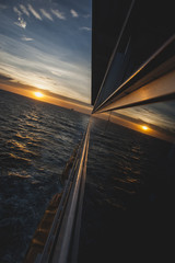 Fototapeta na wymiar Side reflections of cruise ship at sunset