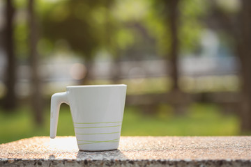 White coffee cup in the park