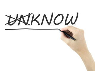 man's hand changing the word unknown into known