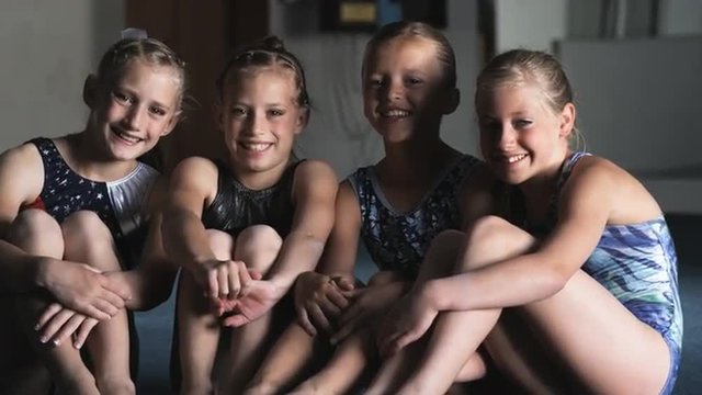 MS Portrait of four smiling girls (8-9, 10-11) in gym, Orem, Utah, USA
