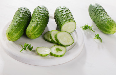 Fresh cucumbers on  cutting board.