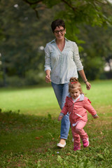 happy family playing together outdoor in park