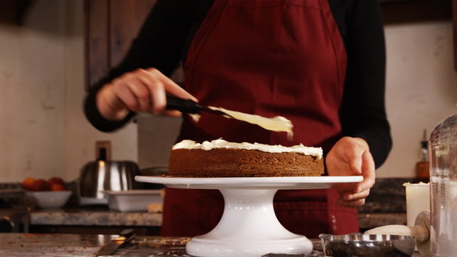 woman frosting a cake
