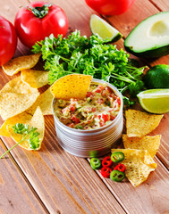 Guacamole with avocado, lime, tomato, and cilantro