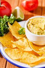 Guacamole with avocado, lime, tomato, and cilantro