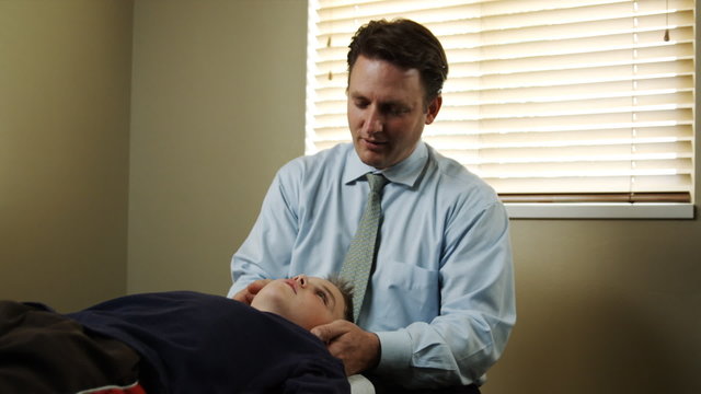 chiropractor adjusting a patient