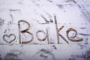 Wooden table top with text on flour