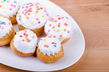 Cake on a white plate with colored sprinkles