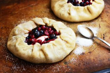 Baking open pie or galette with apples and berries
