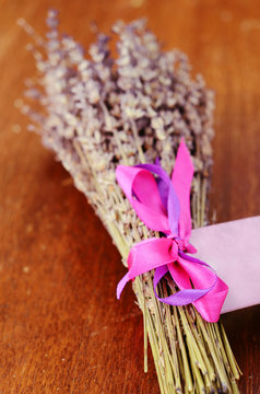 Bunch of dried lavender on brown wooden table