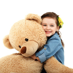 Little girl with big teddy bear having fun laughing