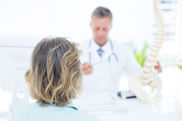 Doctor showing spine model to his patient