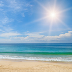ocean, sandy beach and blue sky
