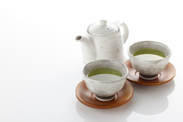 Japanese green tea in porcelain cup and tea pot.