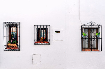 Windows with steel lattice on a whitewashed wall