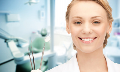 happy young female dentist with tools