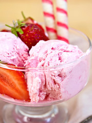 Ice cream strawberry in glass bowl with waffles on board