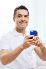 happy man with smartphone at home