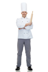 happy male chef cook holding rolling pin