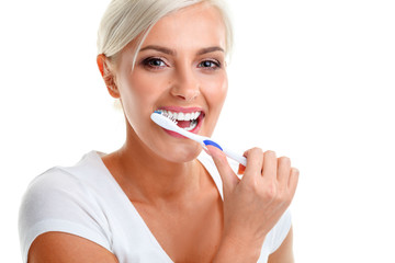 young lady holding toothbrush and smiling