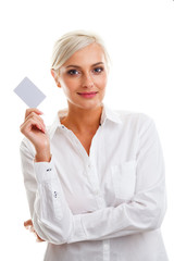 Happy blond woman showing blank credit card