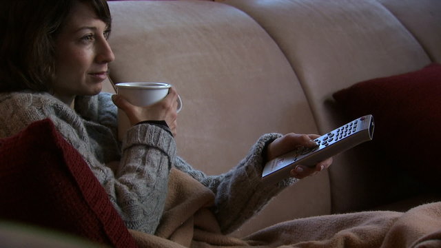 A woman relaxing watching television