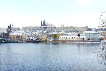 Fototapeta na wymiar Snowy Prague gothic Castle above River Vltava