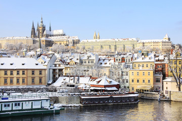 Fototapeta na wymiar Snowy Prague gothic Castle above River Vltava 