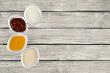 Red. The various barbecue sauces in ceramic bowls