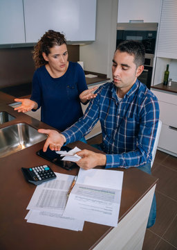 Unemployed young couple with debts reviewing their bills