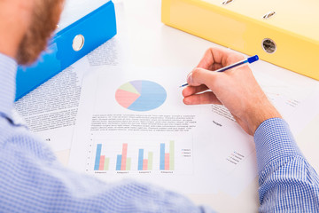 Employee is working at his desk with documents