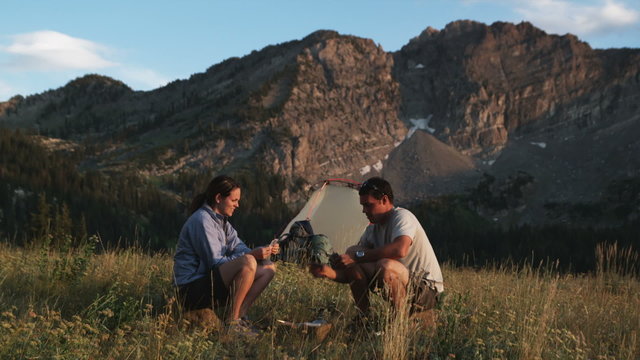 couple playing cards at their campsite