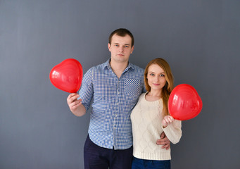 Beautiful couple in love with red balloon heart 