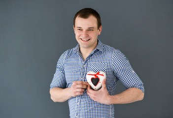 Young man holding a heart. Valentine's Day.