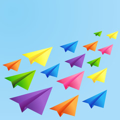 Fototapeta na wymiar Set of flying color paper planes on the blue background