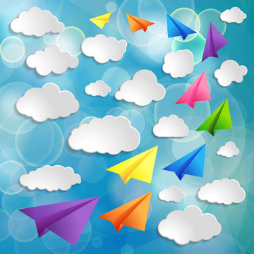 Set of flying colorful paper airplanes with clouds on the blue b