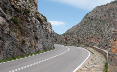 Fototapeta premium Empty rural road passing via a beautiful gorge