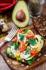 Bruschetta with tomato, avocado and quail egg