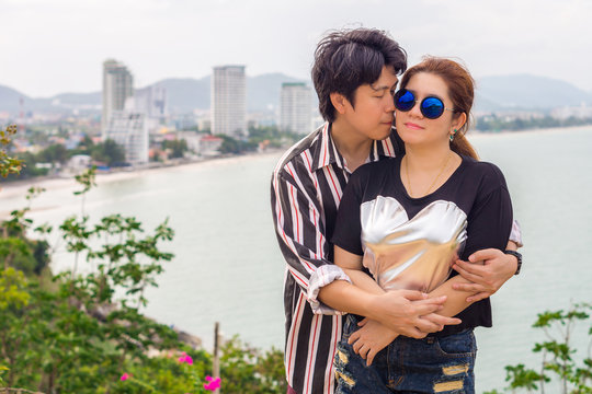 Romantic Asian couple kissing. Happy Thai man and woman