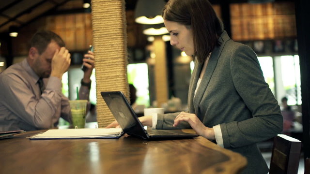 Businesspeople working with documents, laptop and smartphone
