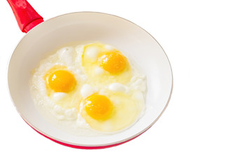 Fried eggs on a white pan