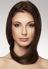 Fototapeta premium Beautiful young woman with magnificent hair looking at camera