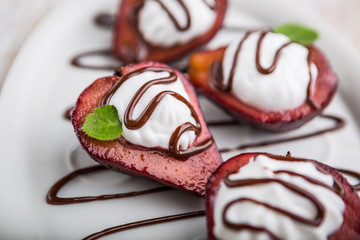 Pears cooked in red wine with whipped cream