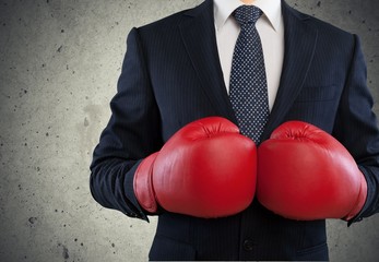 Boxing. Businessman in boxing gloves on background
