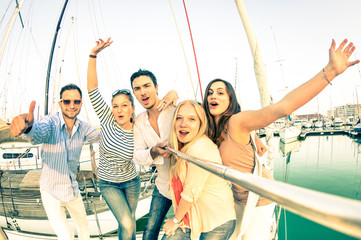 Best friends using selfie stick taking pic on luxury sail boat