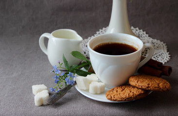 A cup of coffee, a sprig of nezabudok and oatmeal cookies.
