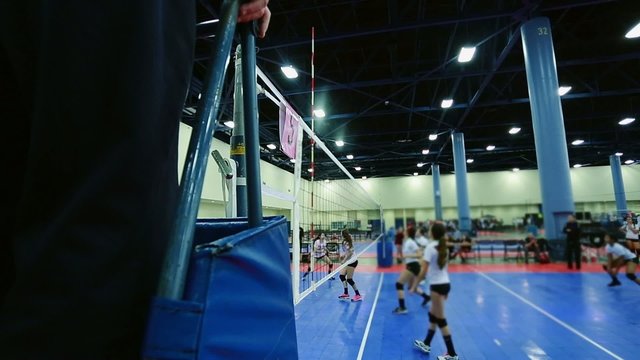 Female Volleyball Game, shot from behind a referee