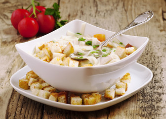 classic chicken noodle soup with crackers, selective focus