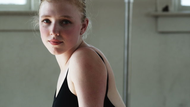 dancer stretching and looking at camera